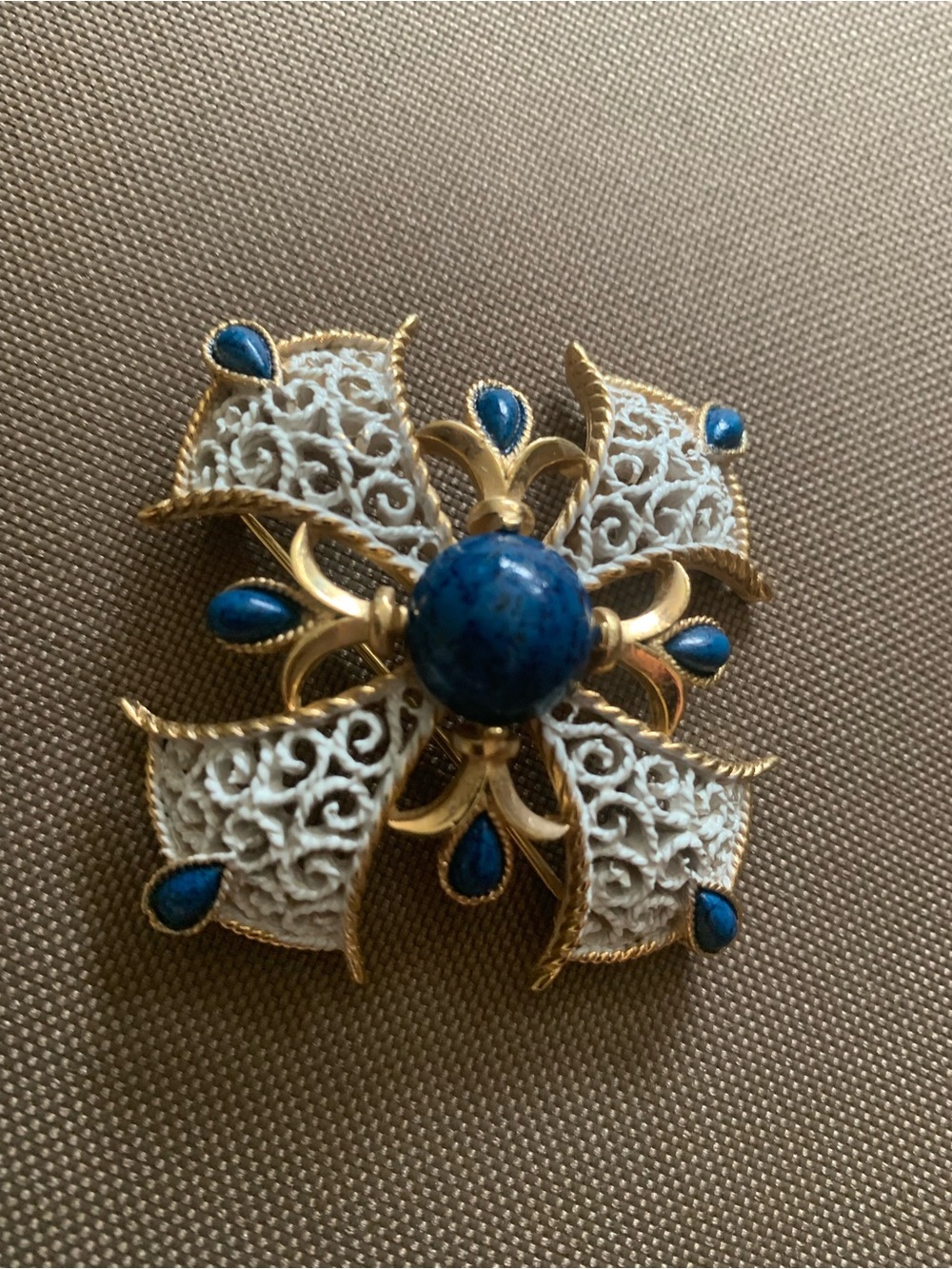 Gold-Tone White Filigree Brooch with Blue Stone Accent